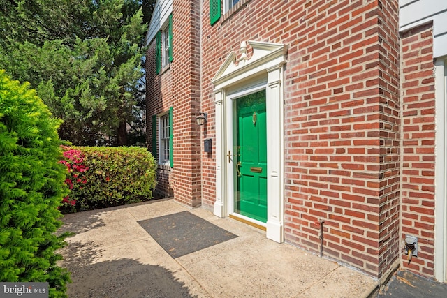 entrance to property with brick siding