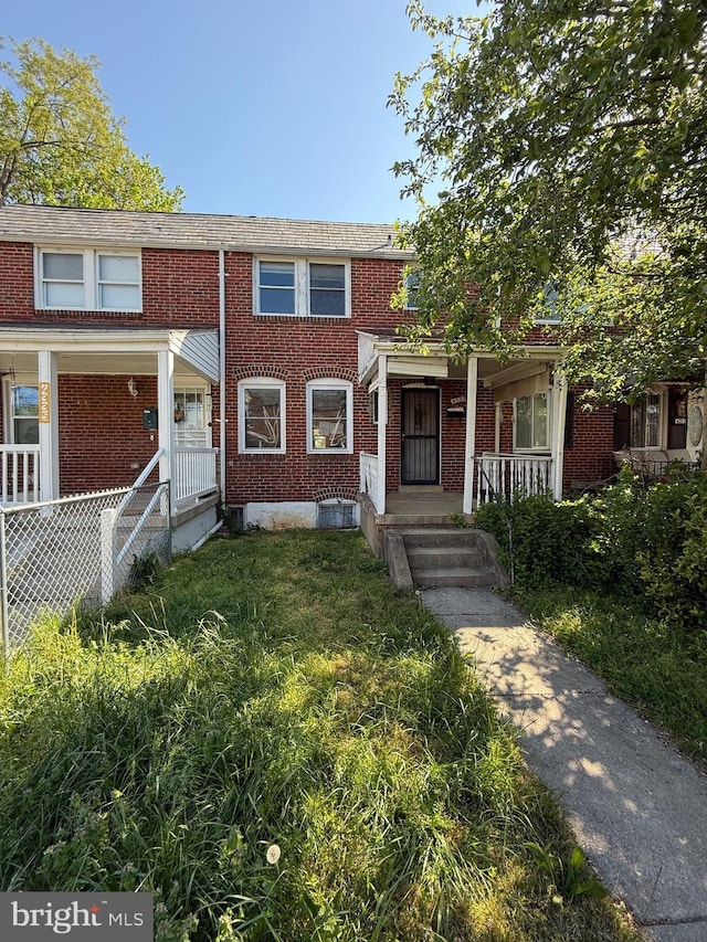 4333 Pimlico Rd, Baltimore, MD 21215 - townhome / multi-family property with a porch and brick siding