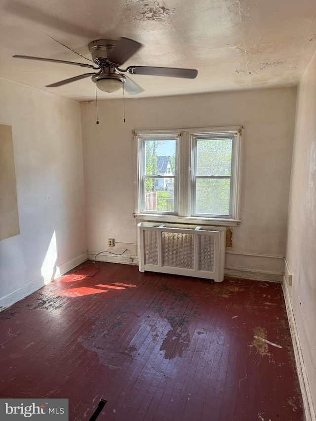4333 Pimlico Rd, Baltimore, MD 21215 - empty room with wood-type flooring, ceiling fan, baseboards, and radiator heating unit