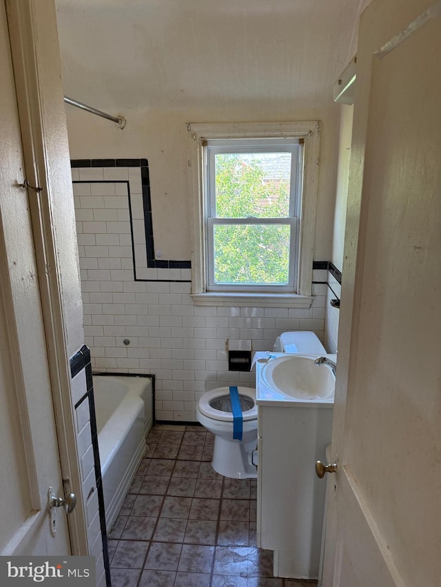 4333 Pimlico Rd, Baltimore, MD 21215 - full bathroom with vanity, toilet, and tile walls