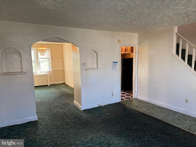 4333 Pimlico Rd, Baltimore, MD 21215 - unfurnished room featuring arched walkways, a textured ceiling, and carpet flooring