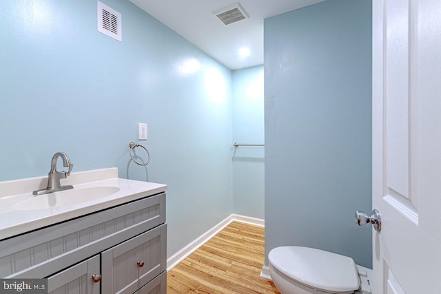7 Teak Ct, Cherry Hill, NJ 08003 - bathroom with visible vents, wood finished floors, toilet, and vanity