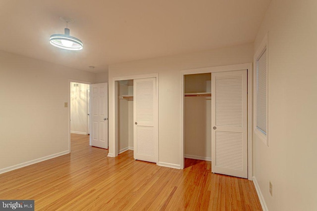 7 Teak Ct, Cherry Hill, NJ 08003 - unfurnished bedroom with baseboards, light wood-style flooring, and multiple closets