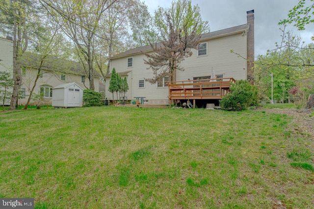 7 Teak Ct, Cherry Hill, NJ 08003 - rear view of property featuring an outdoor structure, a chimney, a deck, a storage shed, and a lawn