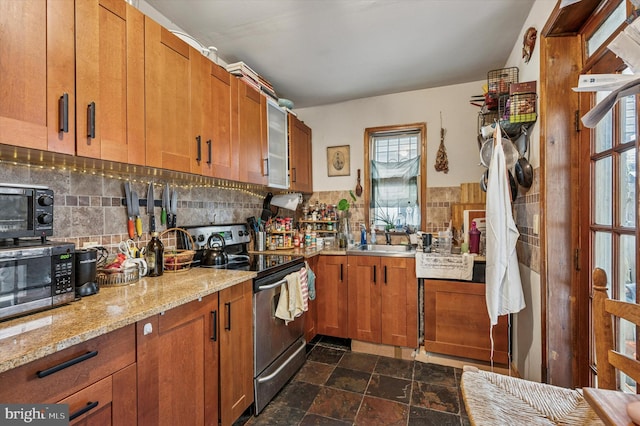 1130 N 3rd St, Philadelphia, PA 19123 - kitchen featuring appliances with stainless steel finishes, healthy amount of natural light, a sink, and dark stone finish floors
