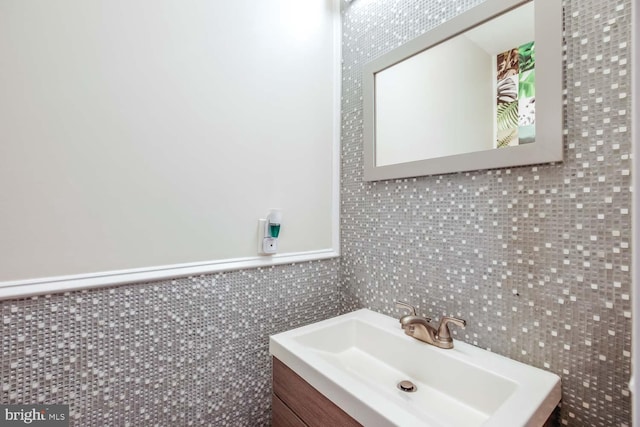 bathroom featuring tile walls and vanity