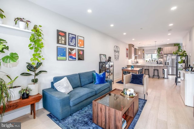 living room featuring recessed lighting and light wood-type flooring