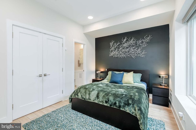bedroom featuring recessed lighting, a closet, and light wood-type flooring