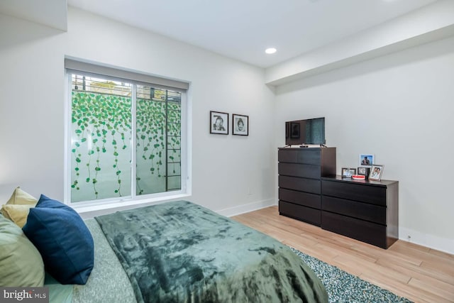 bedroom featuring recessed lighting, light wood finished floors, and baseboards