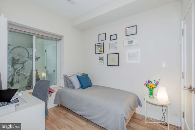 bedroom with light wood-style flooring and baseboards