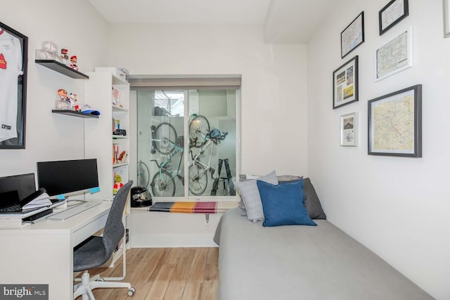 bedroom featuring wood finished floors and baseboards
