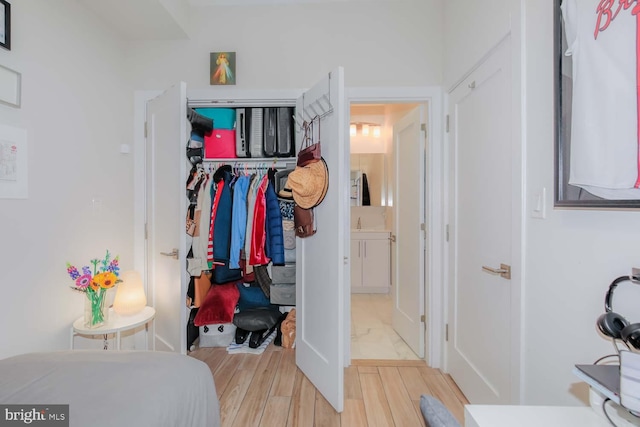 bedroom featuring a closet and light wood-type flooring