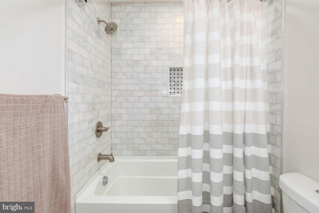 full bath with shower / tub combo and toilet