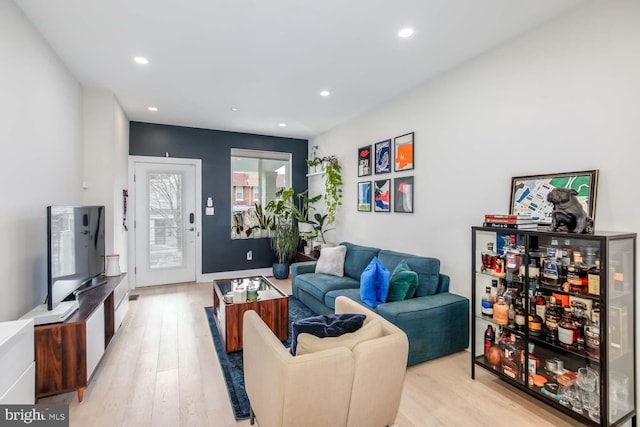 living area with recessed lighting and light wood-style flooring