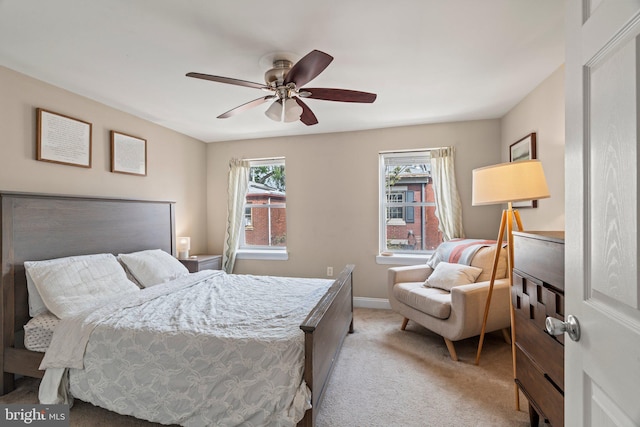 bedroom featuring ceiling fan, baseboards, and light carpet
