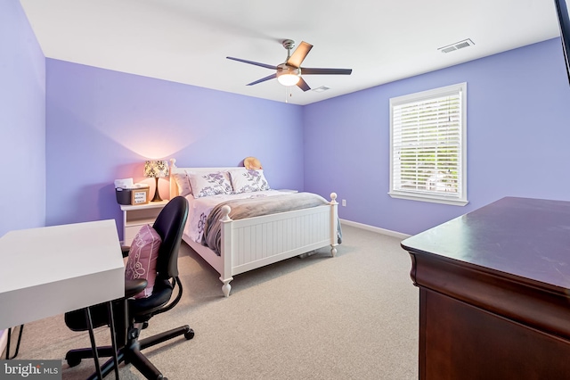 carpeted bedroom featuring a ceiling fan, visible vents, and baseboards