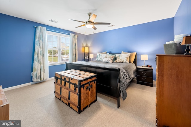 bedroom with a ceiling fan, visible vents, light colored carpet, and baseboards