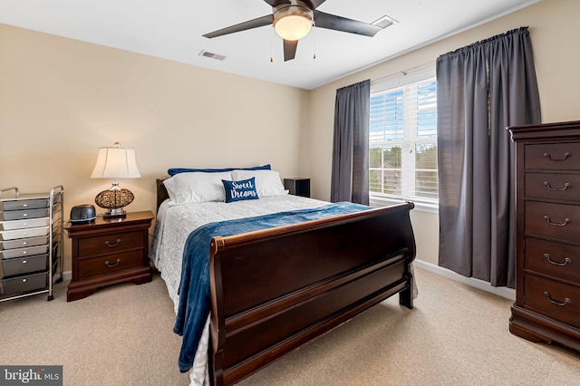 bedroom featuring visible vents, baseboards, and light carpet