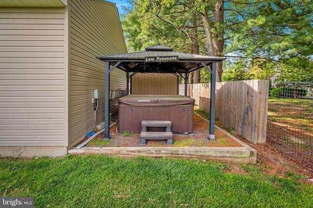 view of yard with fence, a gazebo, and a hot tub