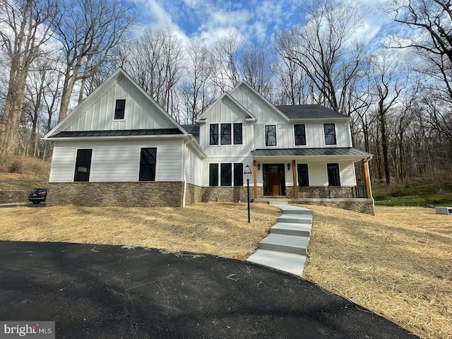 937 Swinehart, Boyertown, PA 19512 - modern inspired farmhouse with board and batten siding, stone siding, a standing seam roof, metal roof, and covered porch