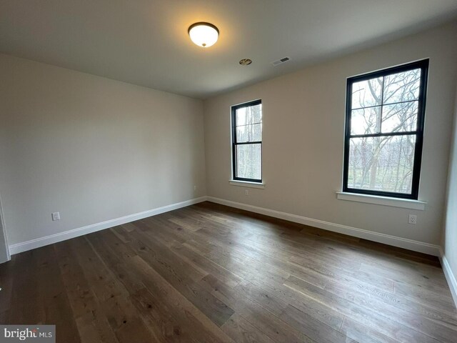 937 Swinehart, Boyertown, PA 19512 - spare room with dark wood-style floors, visible vents, and baseboards
