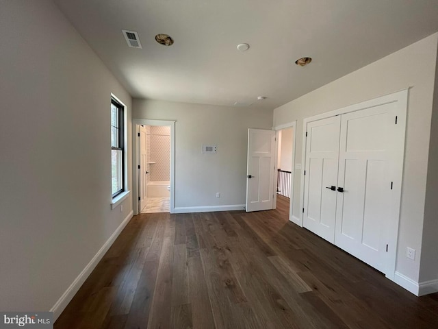 937 Swinehart, Boyertown, PA 19512 - unfurnished bedroom featuring connected bathroom, visible vents, dark wood-style floors, a closet, and baseboards