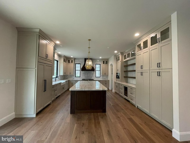 937 Swinehart, Boyertown, PA 19512 - kitchen with recessed lighting, custom exhaust hood, a center island, baseboards, and wood finished floors