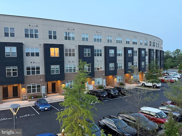 view of building exterior featuring uncovered parking