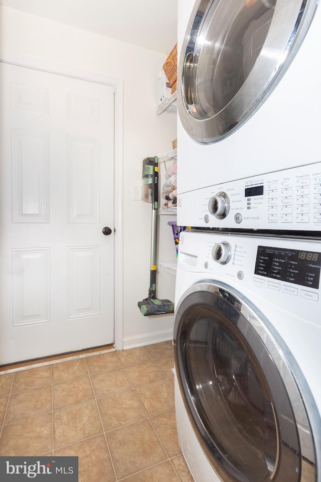 3560 Sherwin Dr, Manchester, MD 21102 - laundry room with stacked washer and clothes dryer, light tile patterned floors, and baseboards