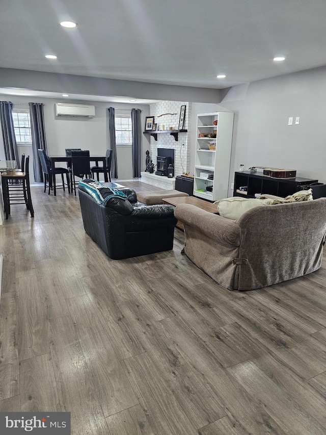 56 Coral Ln, Levittown, PA 19055 - living room featuring recessed lighting, a wall unit AC, wood finished floors, and plenty of natural light
