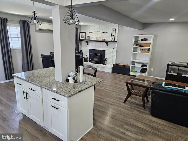 56 Coral Ln, Levittown, PA 19055 - kitchen with dark wood-type flooring, white cabinetry, light stone counters, pendant lighting, and open floor plan