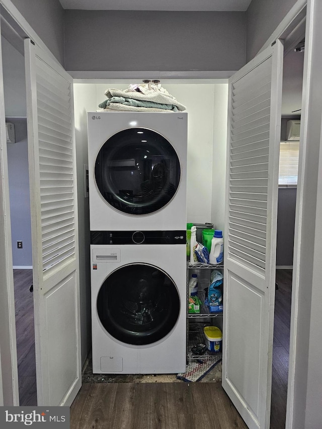 56 Coral Ln, Levittown, PA 19055 - washroom with wood finished floors, stacked washer / dryer, and laundry area