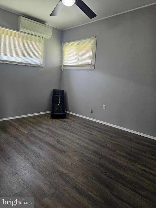 56 Coral Ln, Levittown, PA 19055 - empty room featuring ceiling fan, a wall unit AC, dark wood finished floors, and baseboards