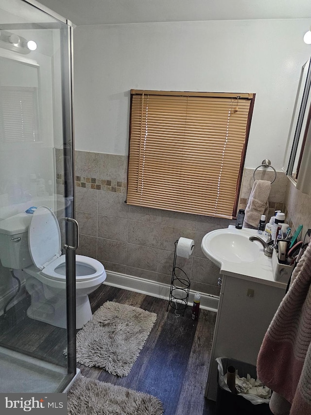 56 Coral Ln, Levittown, PA 19055 - full bath with tile walls, a shower stall, vanity, toilet, and wood finished floors
