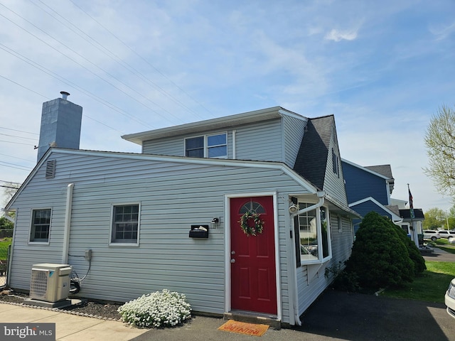 56 Coral Ln, Levittown, PA 19055 - view of front of home with a chimney, central AC unit, and ac unit