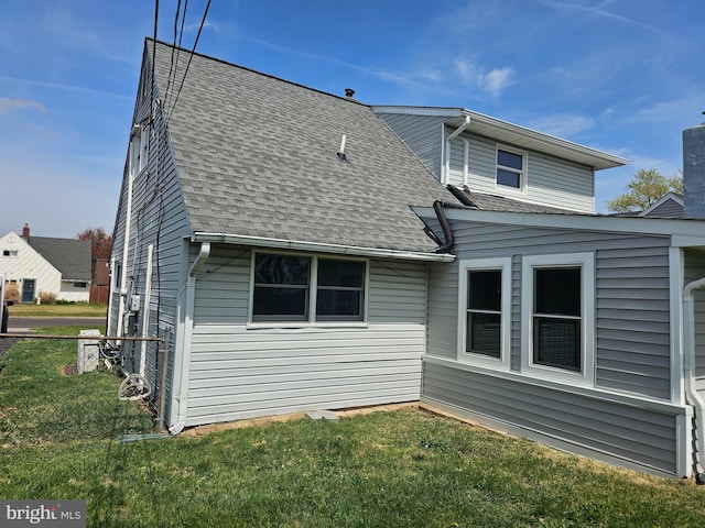 56 Coral Ln, Levittown, PA 19055 - rear view of property featuring a yard, a shingled roof, and fence