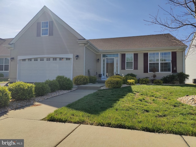117 E Clarendon Dr, Smyrna, DE 19977 - view of front of house with an attached garage and a front lawn