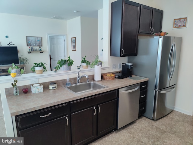117 E Clarendon Dr, Smyrna, DE 19977 - kitchen featuring a sink, dark cabinetry, visible vents, light countertops, and appliances with stainless steel finishes
