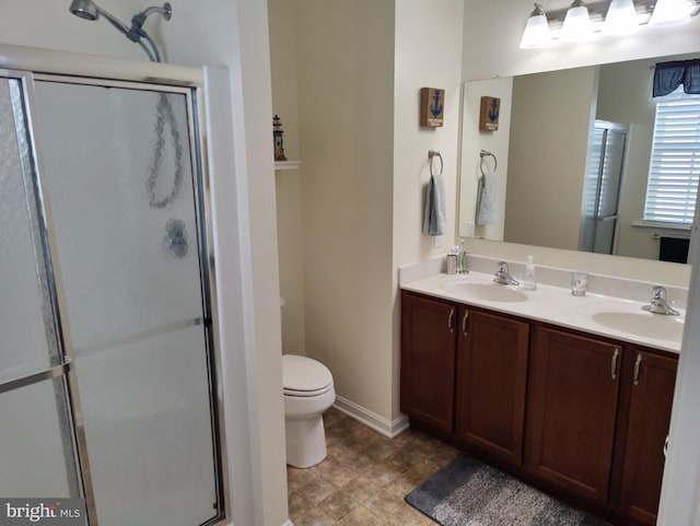 117 E Clarendon Dr, Smyrna, DE 19977 - full bathroom featuring a shower stall, toilet, double vanity, and a sink