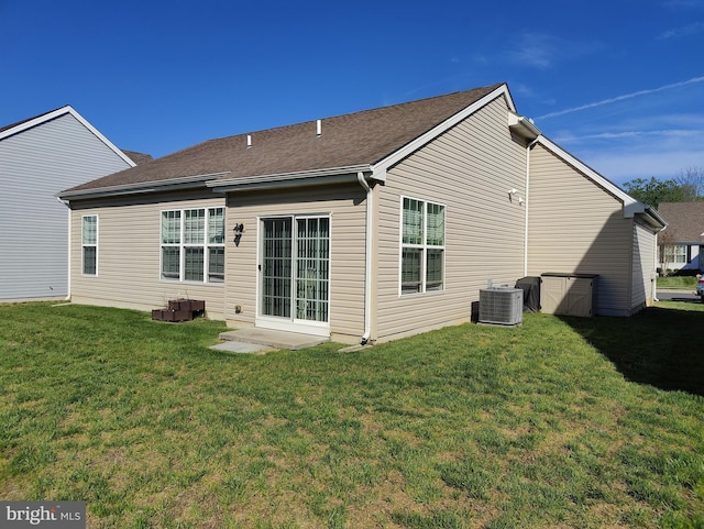 117 E Clarendon Dr, Smyrna, DE 19977 - back of house featuring central air condition unit, a yard, and a shingled roof