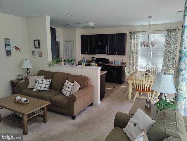 117 E Clarendon Dr, Smyrna, DE 19977 - living room with visible vents, a notable chandelier, and light carpet