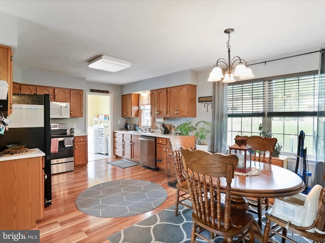 29 Blueberry Ln, Keyser, WV 26726 - dining room with an inviting chandelier, light wood-type flooring, and washer / clothes dryer