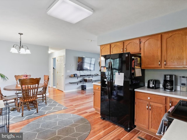 29 Blueberry Ln, Keyser, WV 26726 - kitchen featuring light wood-style flooring, hanging light fixtures, a chandelier, black appliances, and light countertops