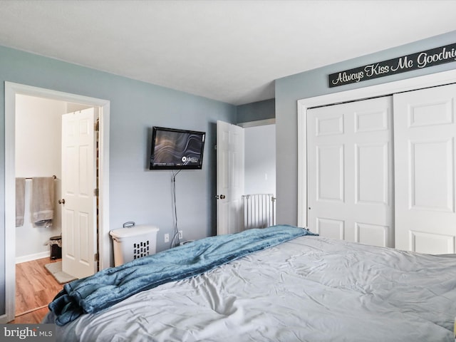 29 Blueberry Ln, Keyser, WV 26726 - bedroom featuring baseboards, a closet, ensuite bath, and wood finished floors
