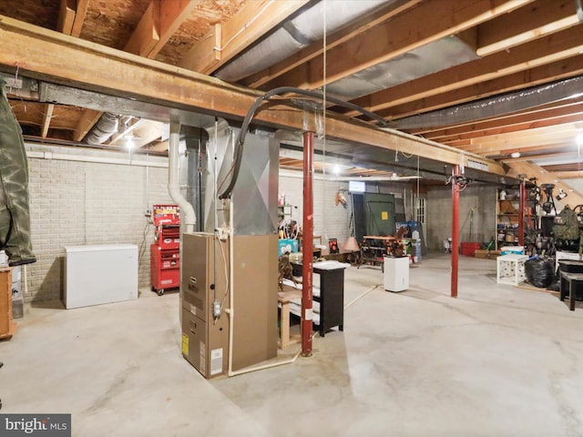 29 Blueberry Ln, Keyser, WV 26726 - unfinished basement featuring heating unit, refrigerator, and brick wall