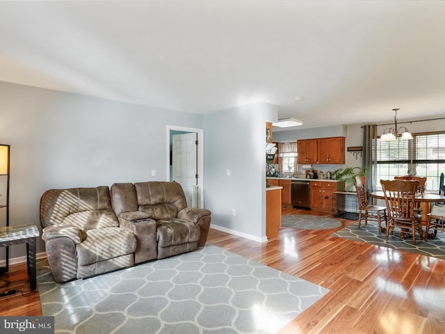 29 Blueberry Ln, Keyser, WV 26726 - living area with plenty of natural light, wood finished floors, baseboards, and a notable chandelier