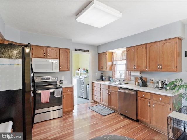 29 Blueberry Ln, Keyser, WV 26726 - kitchen with light countertops, a sink, light wood-type flooring, independent washer and dryer, and appliances with stainless steel finishes