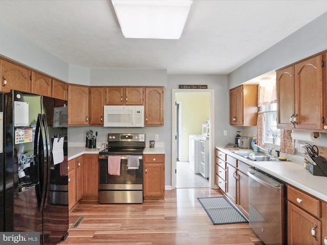 29 Blueberry Ln, Keyser, WV 26726 - kitchen with a sink, stainless steel appliances, washer and clothes dryer, light countertops, and light wood-style floors