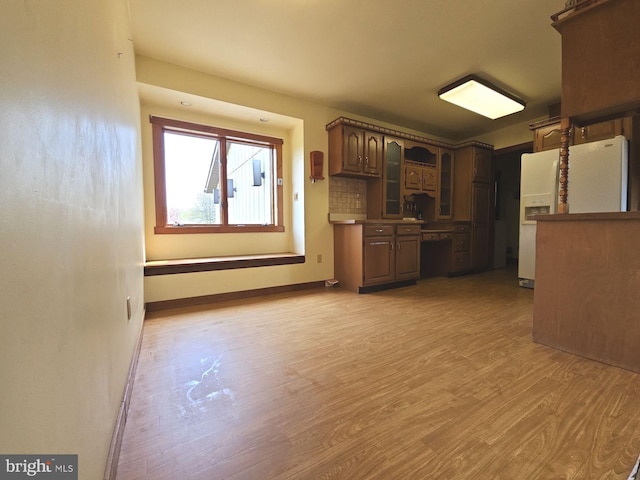 interior space with baseboards and light wood-style floors