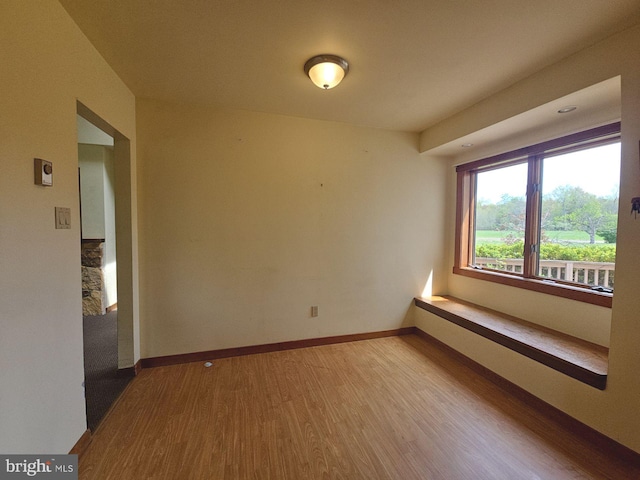 spare room with wood finished floors and baseboards